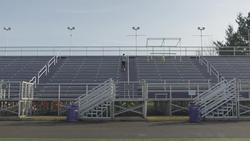 Man Exercising At Stadium