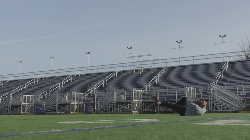 Man Exercising At Stadium
