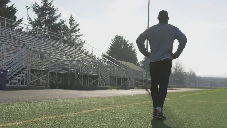 Man Exercising At Stadium