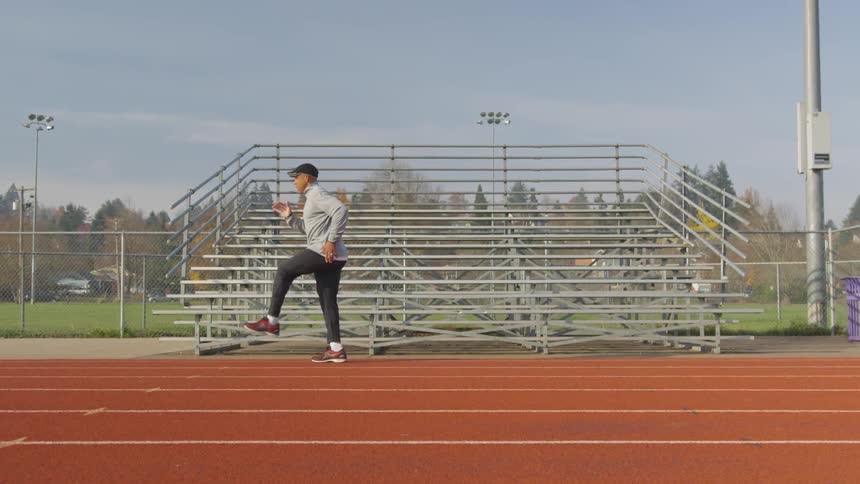 Man Exercising At Stadium
