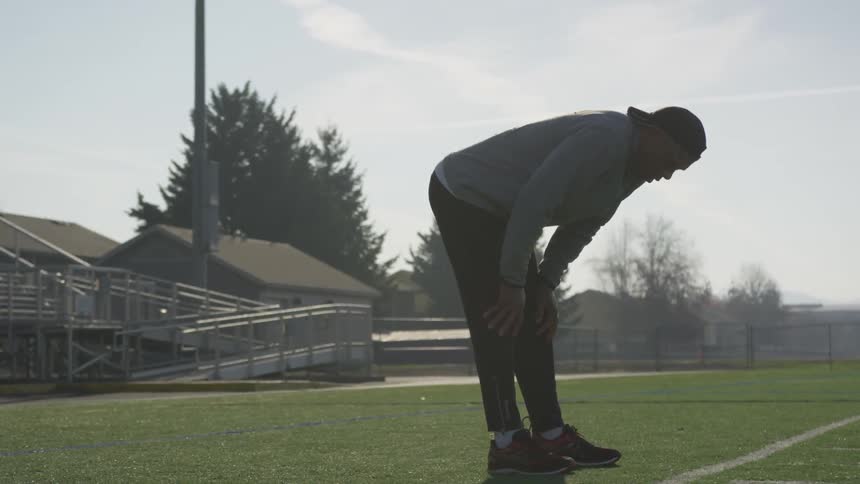 Man Exercising At Stadium