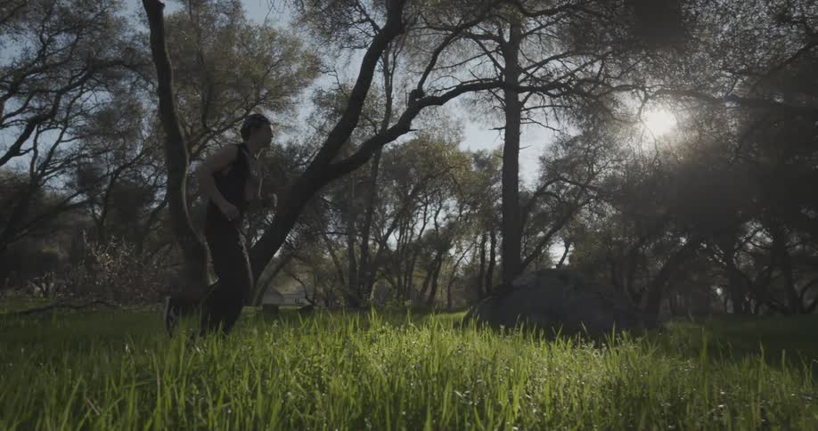 A man running across a grass field