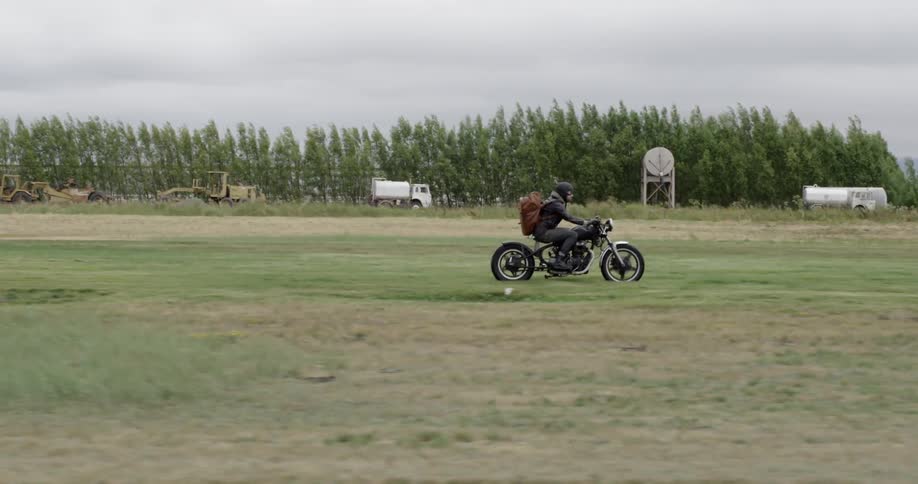 A man riding a motorcycle in a field
