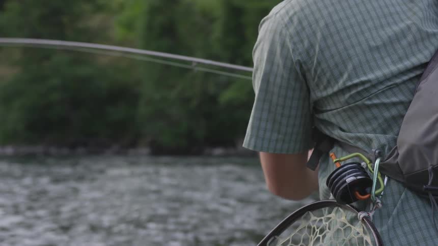 Man pulls fishing line down from pole