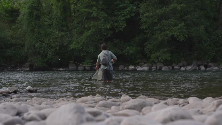 A man is casting a line in the river