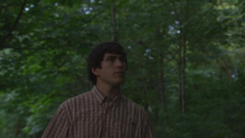 Man walks in thick forest
