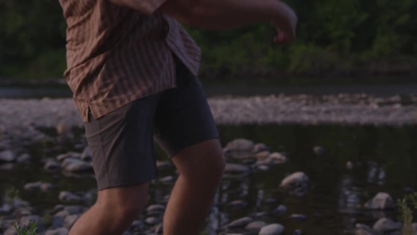 Man throw stone while standing in water
