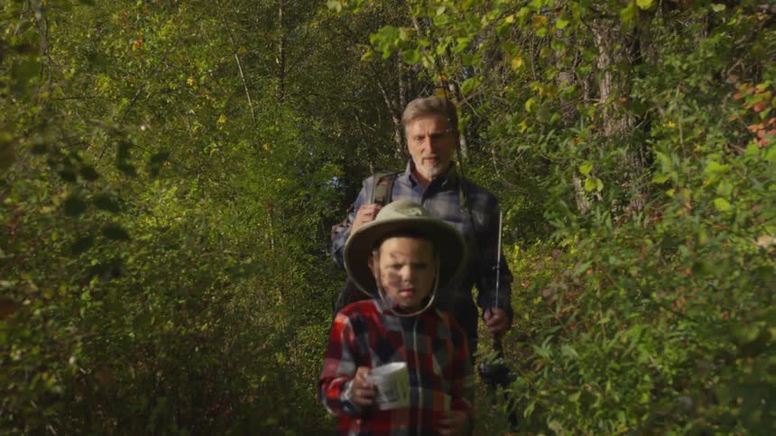 Man and boy walking through the woods