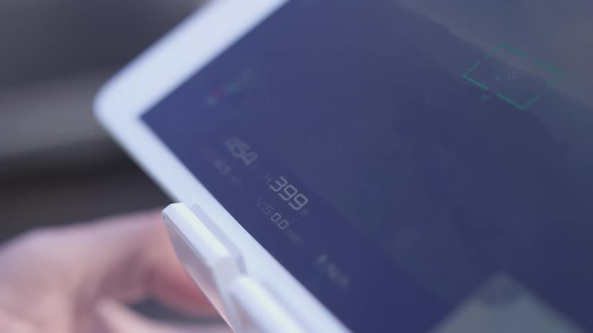 A tablet with a white bezel and numbers on the screen of it