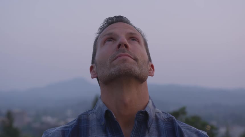 A man looks up into the sky
