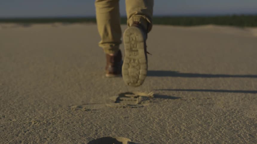 A person is walking in a muddy area