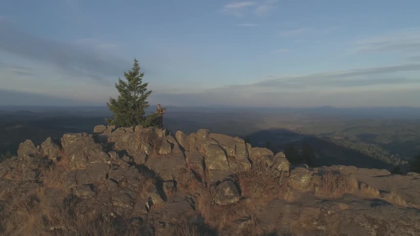 A person is standing on top of a mountain