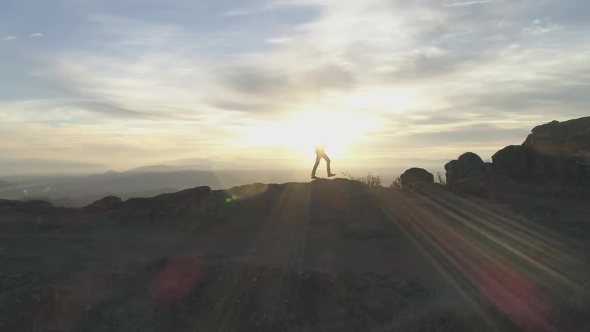 A person walking over a rocky terrain