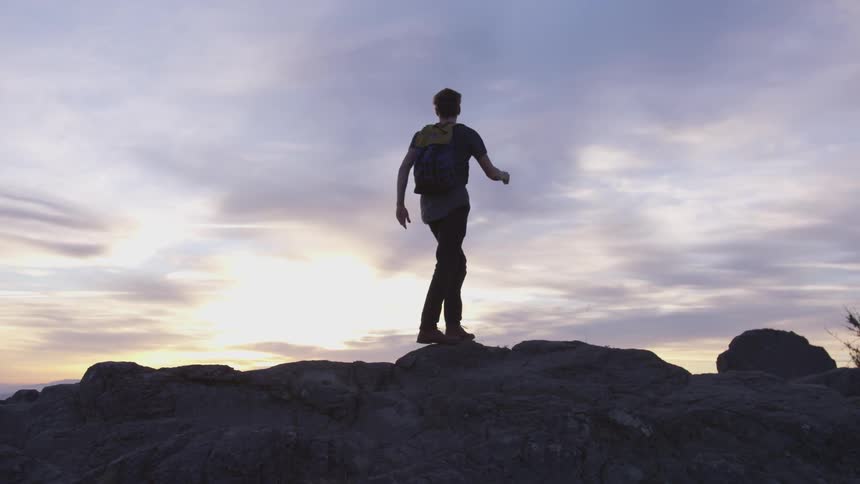 A man jumping from rock to rock