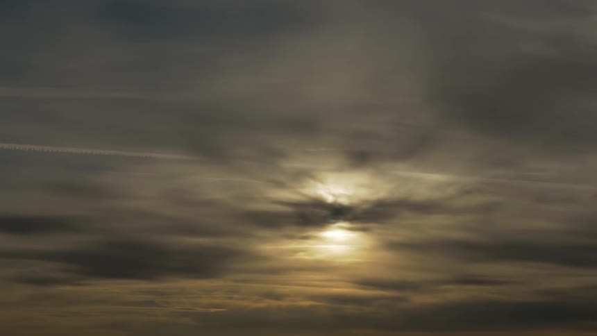 Clouds float in the sky while sun shines