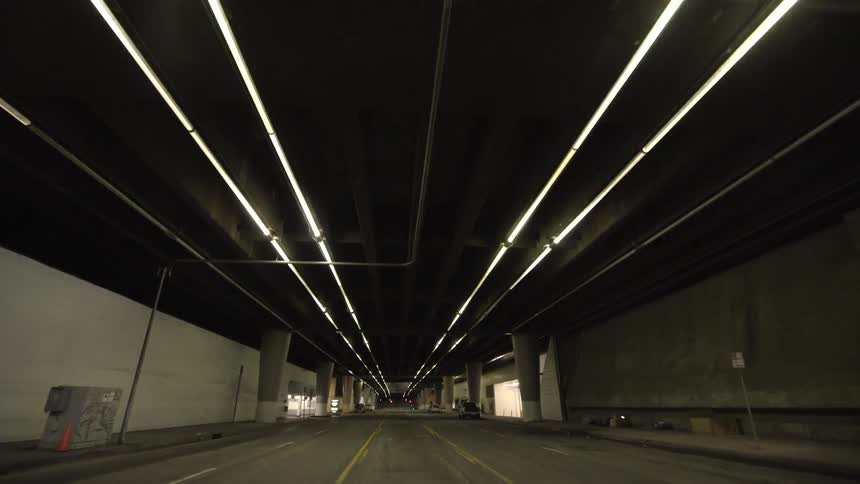 Moving down a street under elevated railways