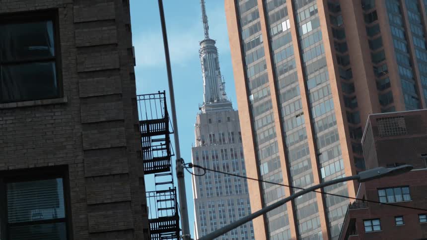 Empire state building seen from between two other buildings
