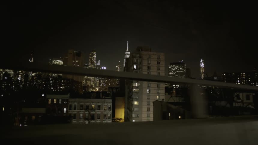 A vehicle driving in a city at night