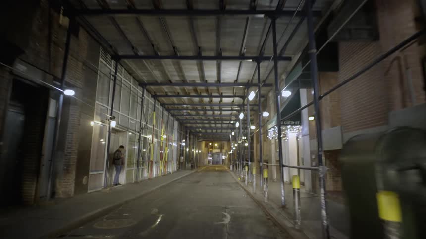 Traveling under a scaffold with a man standing in one doorway