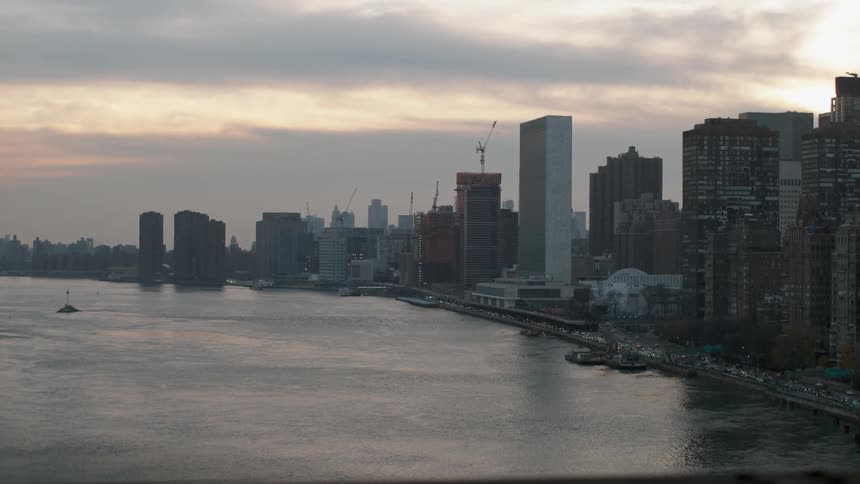 View of a large city across the water on a cloudy day
