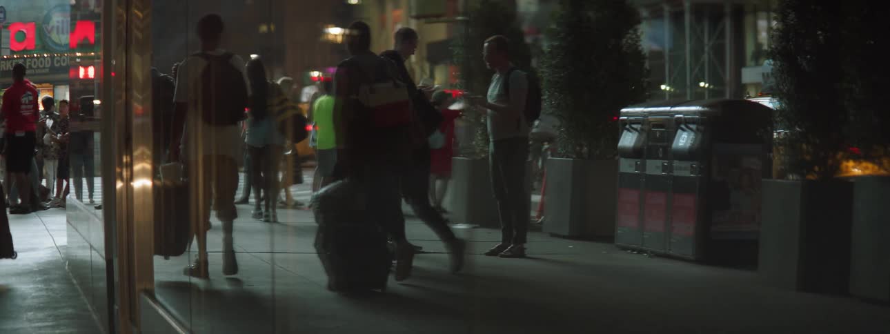 People walking down city street