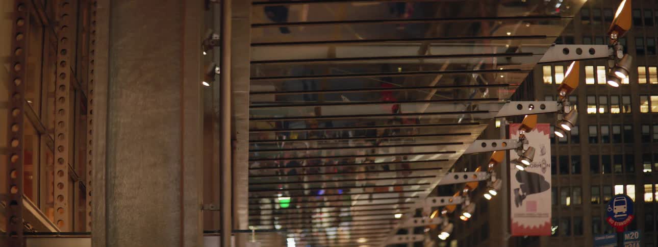 Building reflection of people walking below