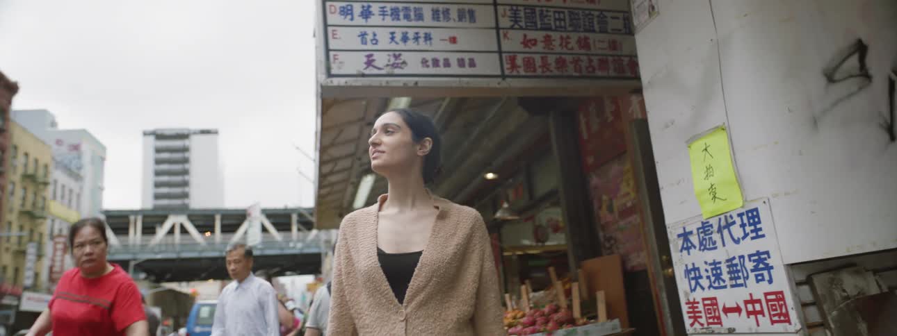 Woman walking down a street in chinatown
