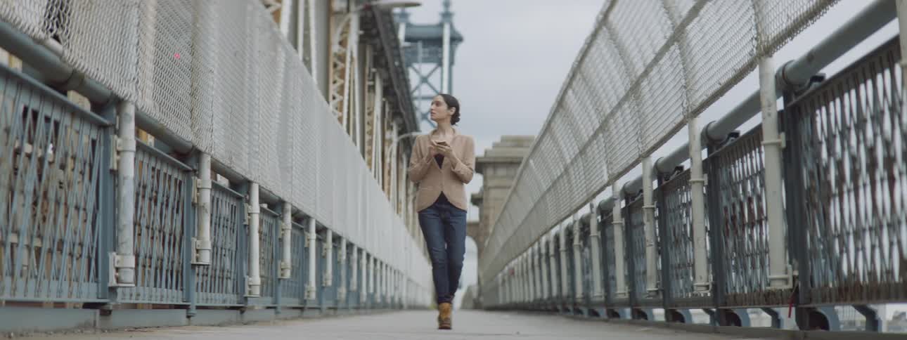 Woman walking over bridge