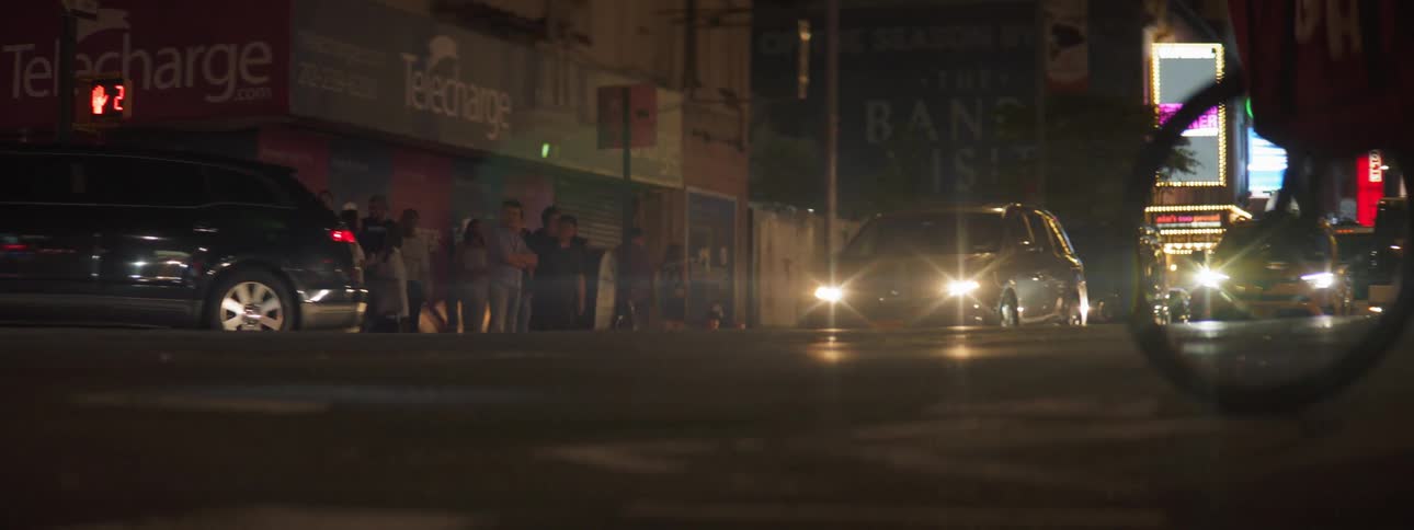 Limousine driving down street with other cars