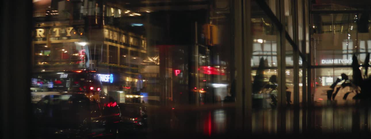 City lights being reflected in window