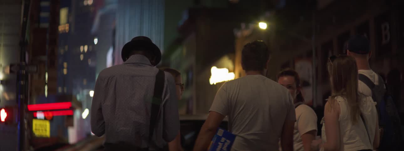 Group of people talking at night in downtown