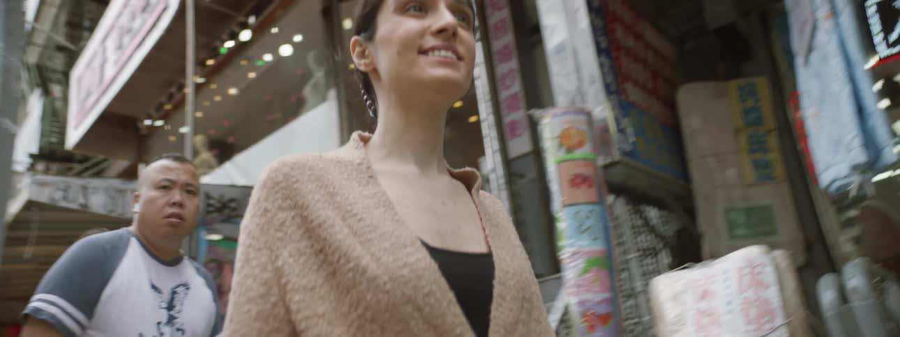 Smiling woman walking down street