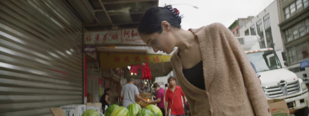Person looks at food in market