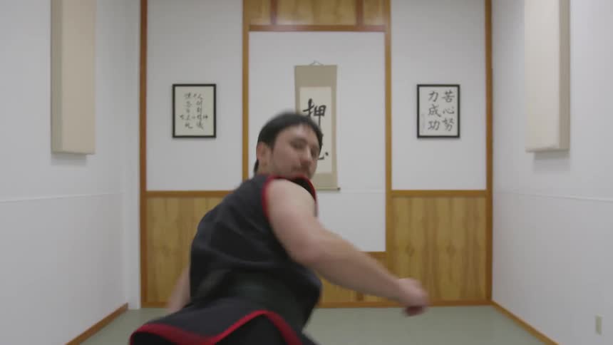 Man Practicing Asian Fighting Techniques