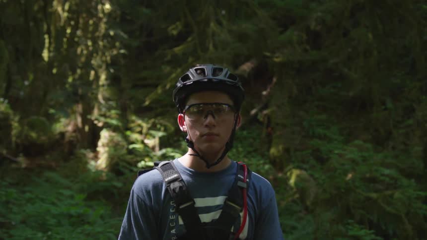 Man Mountain Biking In Forest