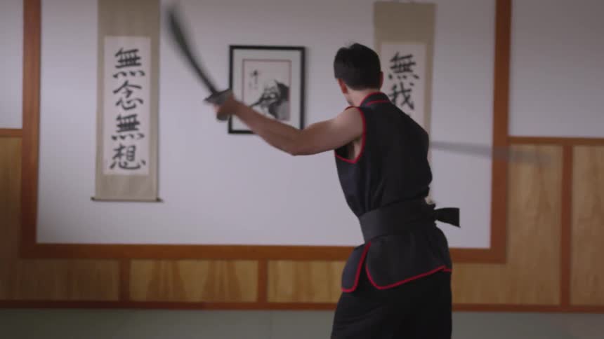 Man Practicing Asian Fighting Techniques