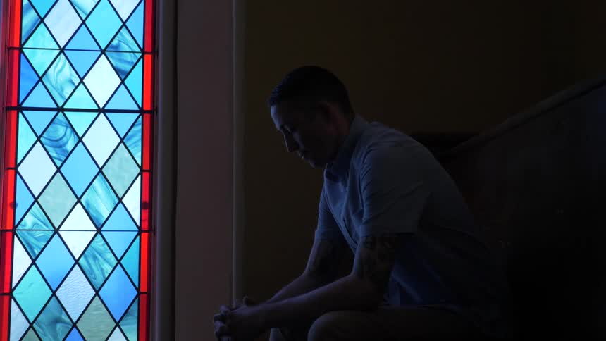 Man Praying At Church