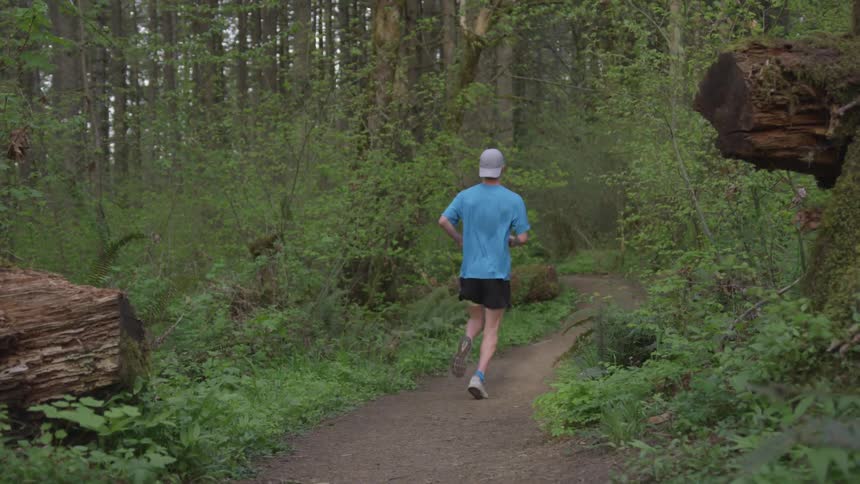 Man Jogging Through Forest