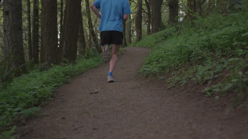 Man Jogging Through Forest
