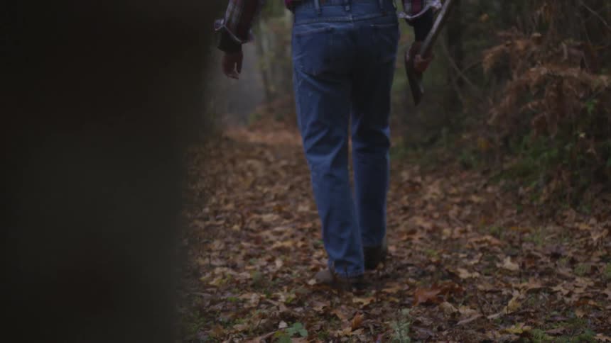 Man In Forest With Weapons