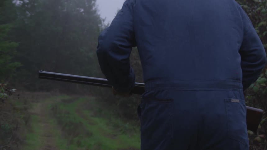 Man In Forest With Weapons