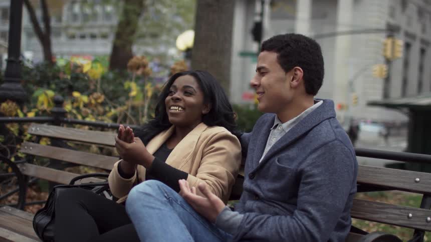A couple sitting on a park bench