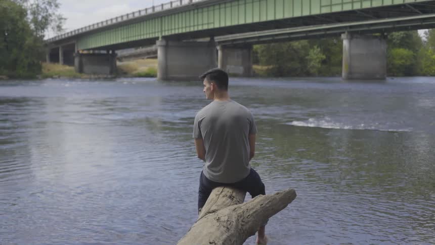Man Sitting By A River