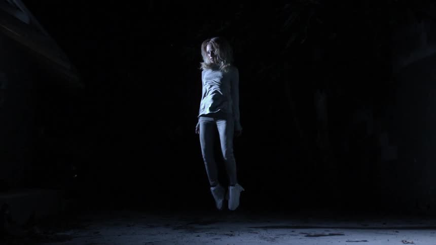 Woman jumps upwards in slow motion