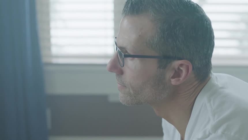 Man Sitting And Thinking On Bed