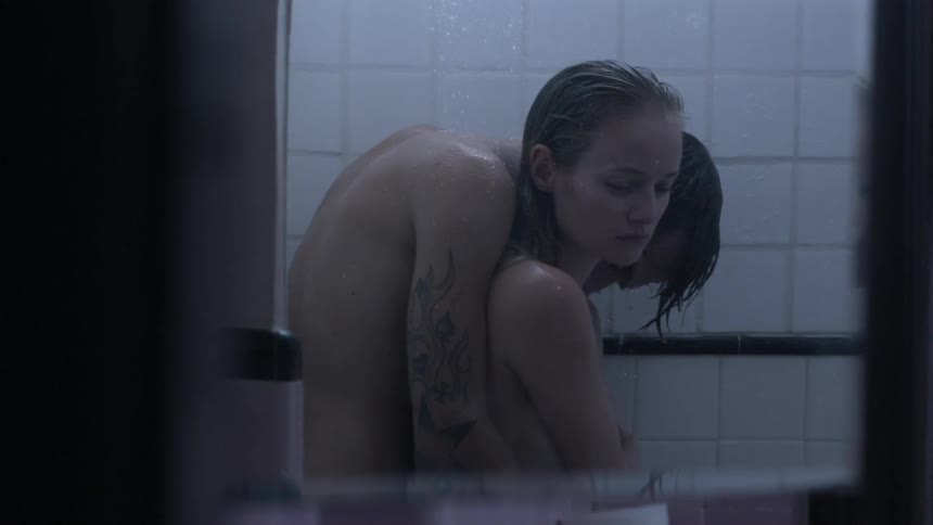 Man and woman embrace while showering