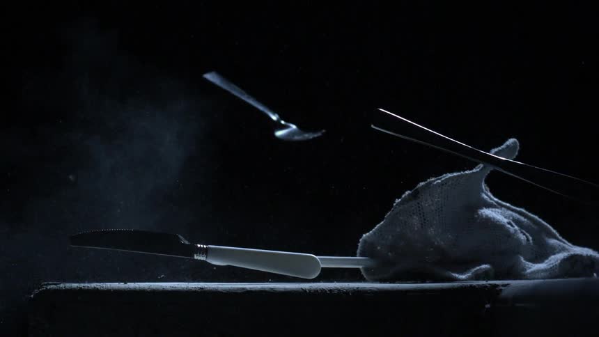 Utensils and cloth fall and then bounce off an object