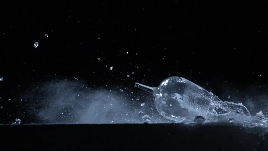 A glass of water falling down to break