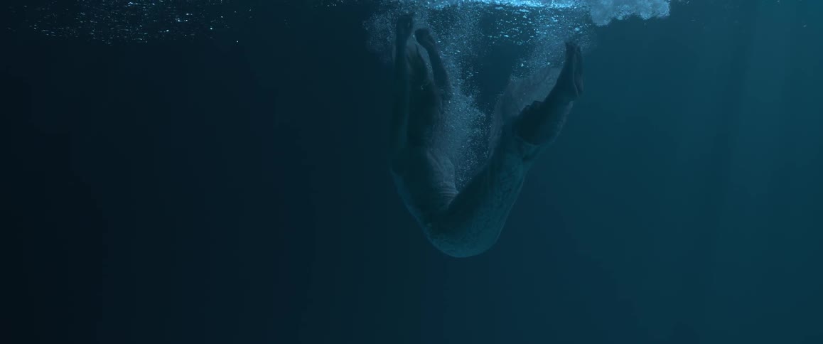 A woman descends into the water in a relaxed position