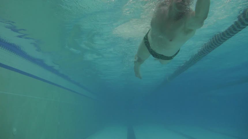 Man Swimming Laps In Indoor Pool
